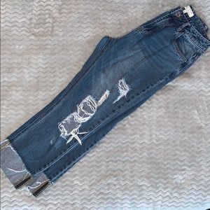 ripped medium wash jeans with cuffed legs
